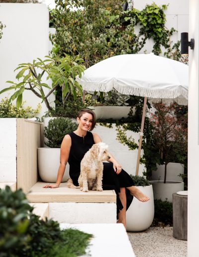 Perth interior designer, Ainslie, with Alfie in beautifully designed courtyard area